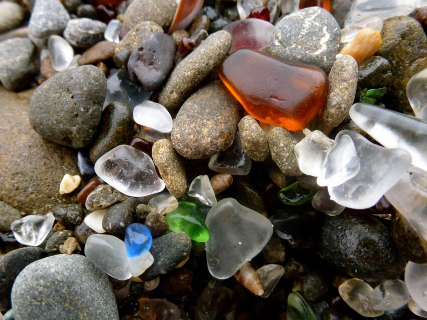 Close-up image of colorful sea glass on a pebble beach.